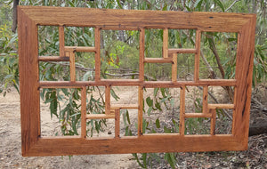 A popular large multi opening photo frame for the wall , hand made in Australia from recycled timbers  for 20 photos this frame is in brown gum